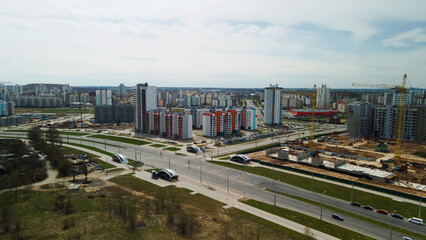 Fototapeta na wymiar Large construction site. Construction of modern multi-storey residential buildings. Construction of apartment buildings from concrete and glass. Aerial photography.