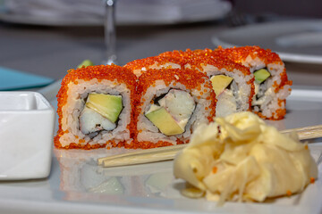 Sushi rolls california with snow crab, cream cheese, cucumber, sesame seeds and masago caviar