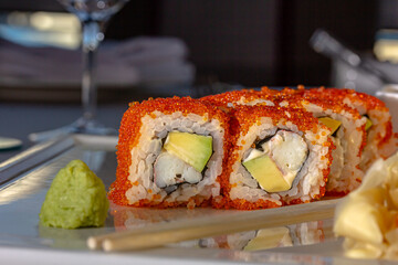 Sushi rolls california with snow crab, cream cheese, cucumber, sesame seeds and masago caviar