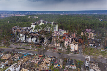 Fototapeta na wymiar The aerial view of the destroyed and burnt buildings. The buildings were destroyed by russian rockets and mines. The Ukrainian cities after the russian occupation.