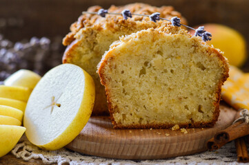 Cake in a cut. Garnished with pears and cinnamon sticks. Homemade baking. Wooden background.
