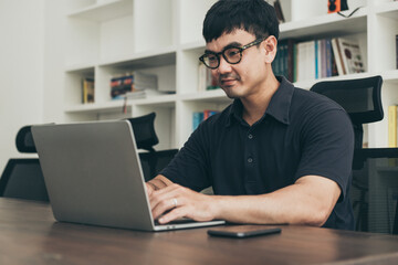 asian man work using computer hand typing laptop keyboard contact us.student study learning education online.adult professional people chatting search at office.concept for technology device business