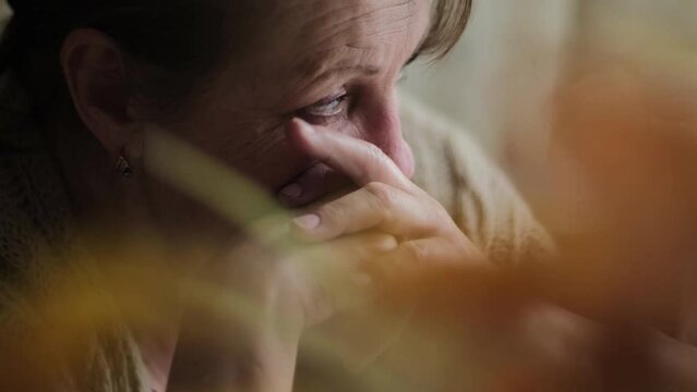 Sad elderly woman thinking about something, closeup