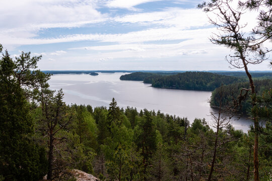View towards lake Pyhajarvi and Kymijoki from top of hill Hiidenvuori in Iitti, Finland..Beautiful landscape in summer with clouds in the blue sky.