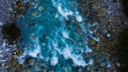 A river blured and looking peaceful rolling over rocks in nature.