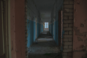 
Abandoned building. A beautiful and scary corridor with shabby walls. Interior of an old abandoned building