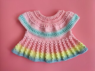 Colorful knitted dress for children. Baby clothes. Rainbow cute kid's jersey. Fashion for kids. Ideas for handmade