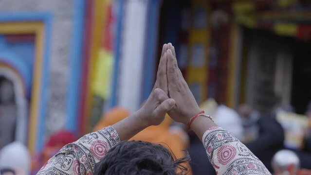 Pilgrim with folded hands in front of Kedarnath Temple, India. Gimbal, shallow focus