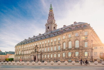 Christiansborg Palace with Christiansborg tower - the seat of the Danish Parliament in the rays of the setting sun. Copenhagen, Denmark - obrazy, fototapety, plakaty