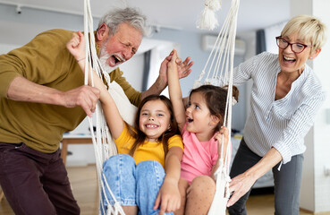 Fototapeta na wymiar Happy grandparents having fun times with children at home