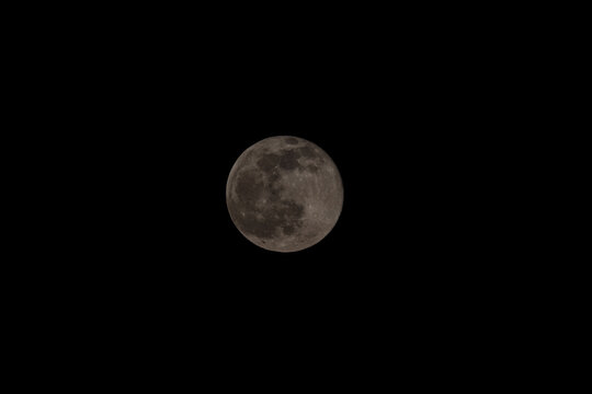 Super full moon with dark black background for placement in video, banner, shot in march 2022, Antwerp, Belgium. High quality photo