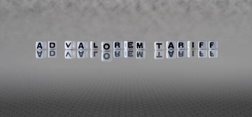 ad valorem tariff word or concept represented by black and white letter cubes on a grey horizon...