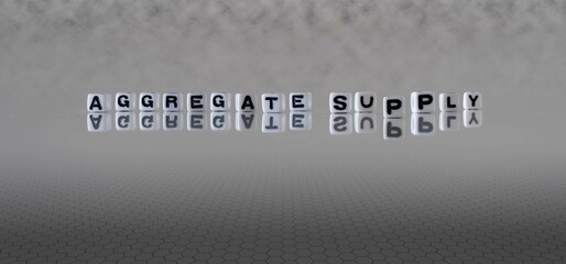 aggregate supply word or concept represented by black and white letter cubes on a grey horizon...