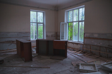 Abandoned building. A beautiful and scary corridor with shabby walls. Interior of an old abandoned building. Light from the window