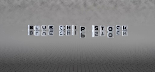 blue chip stock word or concept represented by black and white letter cubes on a grey horizon...