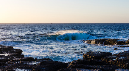 Evening scene on sea, stones, calm ocean