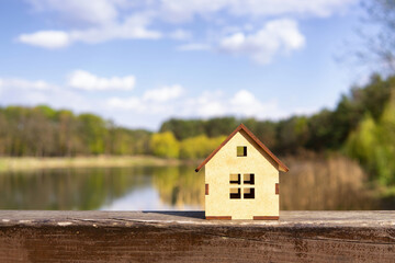 Wooden house model by the lake