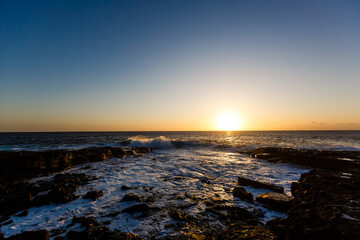 Evening scene on sea, stones, calm ocean