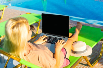 casual woman relaxing with a laptop on vacation