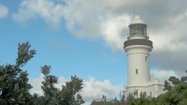 A couple can be seen admiring the view from the base of the Cape Byron Lighthouse