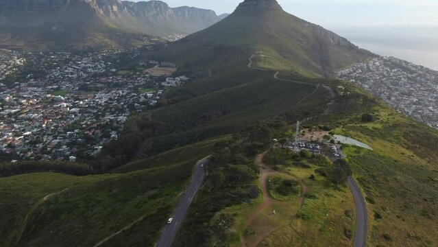 Drone shot of Signal Hill in Cape Town - drone is reversing from Signal Hill, facing Lions Head and Table Mountain. Snippet could ideally be used for travel related videos or Cape Town movies.