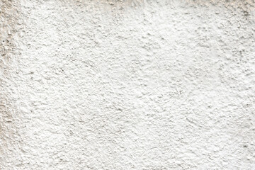 a concrete wall painted with white spray paint