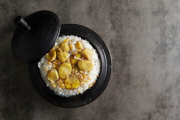 Ripe chestnut topping on cast iron pot rice