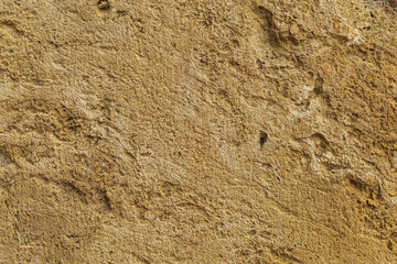 Beige yellow sandstone background, ancient rough sand rock textured surface