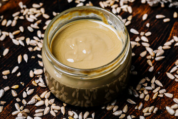 Organic sunflower oil in a bowl and seeds. Top view