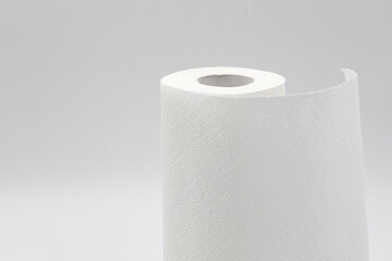 roll of white paper napkins for kitchen and cleaning on a white background close-up