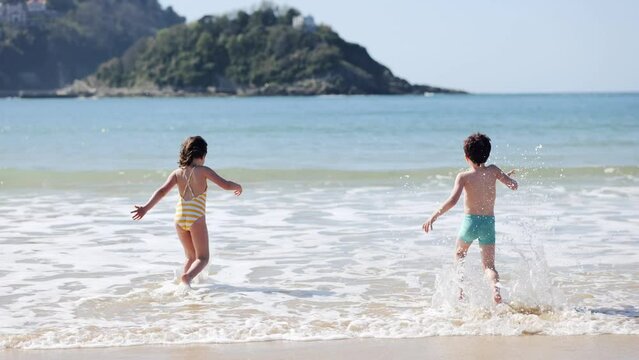 Happy children on wet coast
