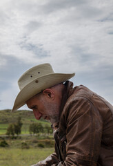 Portrait of adult man in cowboy hat on field