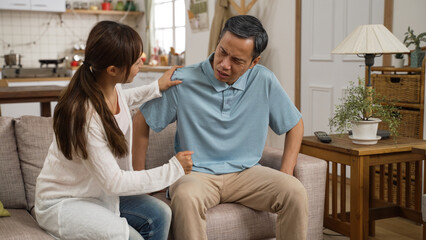 asian elderly dad suffering painful knees having difficulty standing up by herself. his adult...