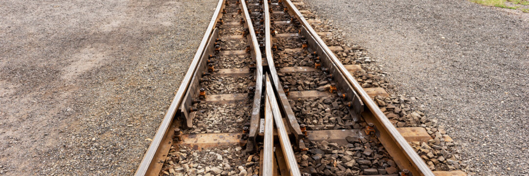 Railway tracks and switch of the narrow gauge railway. Panoramic image