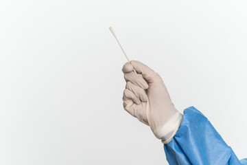 Female doctor or nurse wearing protective suit is holding a cotton swab