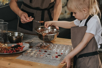 Mom and daughter make chocolate at home