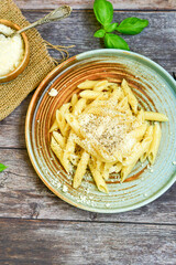 Home made  italian Penne rigate Pasta  with parmesan cheese,garlic  and black pepper .Pasta cacio e pepe. Mediterranean food concept