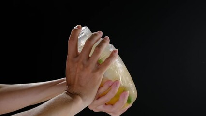 Front view of using shaker full of cold iced in black background 