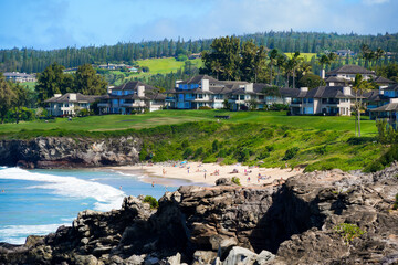 Oceanfront timeshare apartment buildings above Oneloa Beach as seen from Hawea Point along the Kapalua Coastal Trail in the west of Maui island, Hawaii
