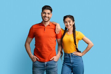 Obraz premium Portrait Of Attractive Young Arab Man And Woman Posing Over Blue Background,
