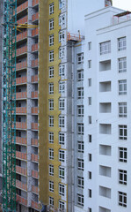 Close-up view the process of building new multi-storey house. Concrete and metal construction of new multi-storey building. Modern concrete structure, building under construction. Abstract background