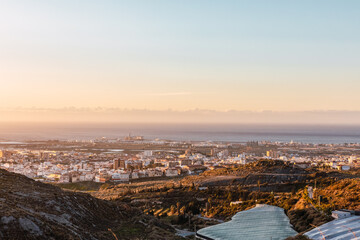 Golden sunset in the greenhouses on the coast of Granada with Motril in the background, Andalucia, Spain