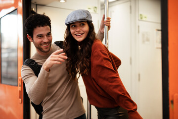 Beautiful couple at railway station waiting for the train. Young woman and man waiting to board a train