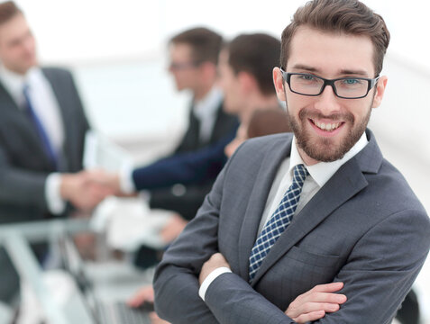 smiling businessman on background of office