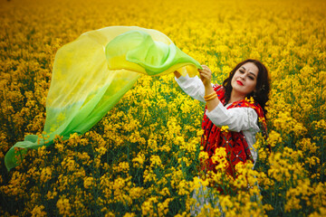 Indian girl in a rapeseed field