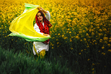 Indian girl in a rapeseed field