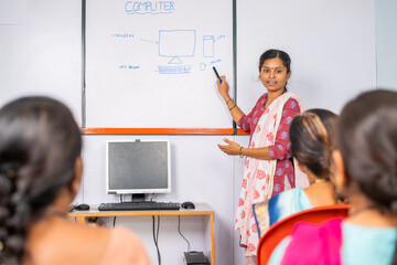 Group of Indian women listening computer class from professional teacher - concept of learning...