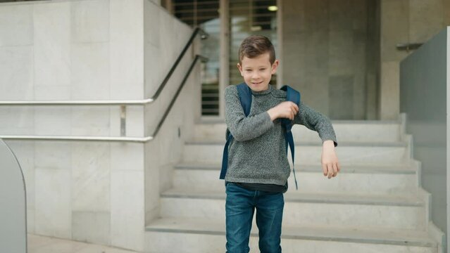 Blond child student smiling confident dancing at school