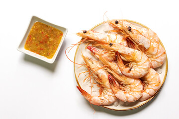 Baked salted banana shrimp (Penaeus merguiensis) usually serve with spicy sauce. Top view isolated on white background.