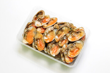 Fresh baby clams in box isolated on white background. Ready to cook for delicious seafood menu.